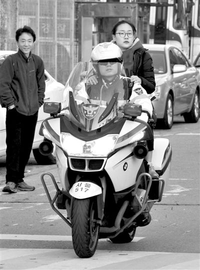 7日，首爾，警察將一名考生送抵考場。新華社發(fā)