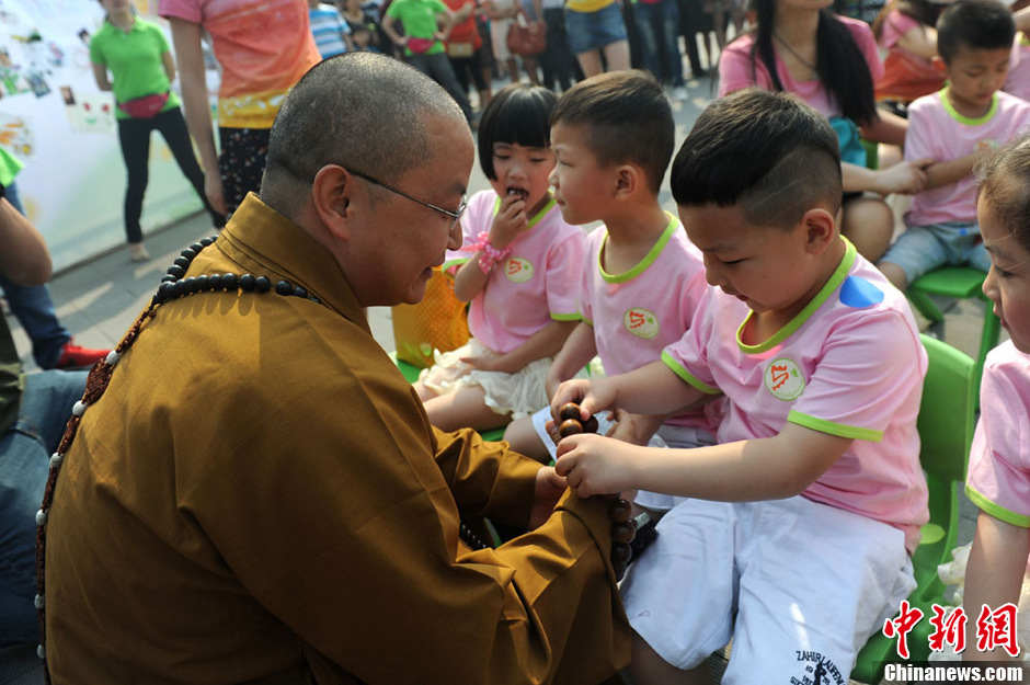 圖為羅漢寺素全法師與參加生日party的孩子。張浪 攝