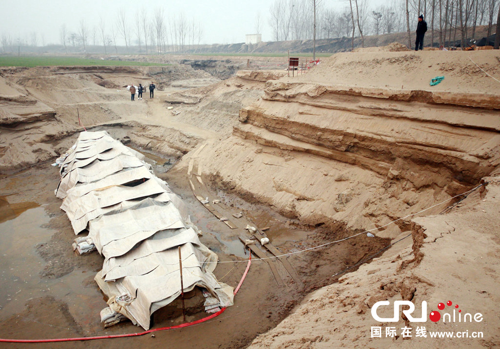 2014年1月6日，河南洛陽(yáng)古沉船發(fā)掘現(xiàn)場(chǎng)，近日有雨雪天，考古人員給古沉船披上一層“雨衣”。