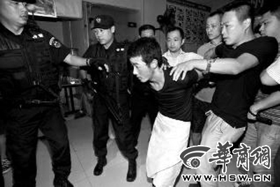 犯罪嫌疑人韓牙某圍著圍裙在廚房?jī)?nèi)拉面，被民警抓獲 本報(bào)記者 鄧小衛(wèi) 攝