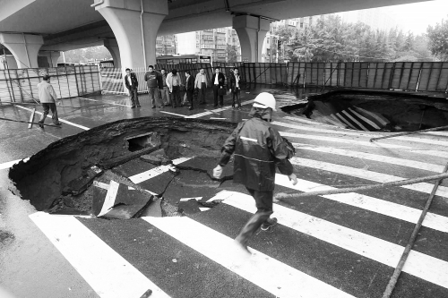 中原路西三環(huán)立交橋下由南向北原本4個(gè)車道，由于塌坑，而今3個(gè)車道被圍擋