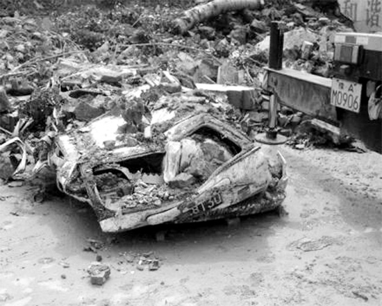 7月2日，新密市區(qū)，暴雨沖倒圍墻，一輛汽車被砸成“鐵餅”