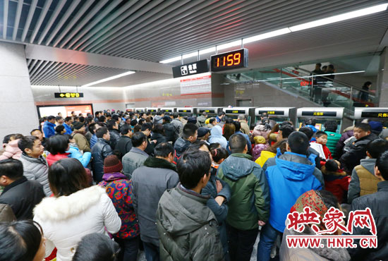 地鐵開通首日，上午十一點五十九分，紫荊山地鐵站售票機前擠滿了買票的市民。