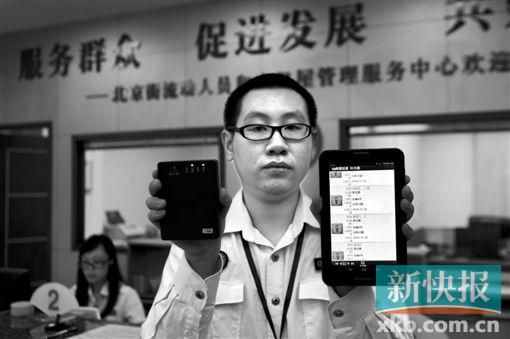 　越秀區(qū)北京街出租屋外來暫住人員管理服務(wù)中心的工作人員展示到出租屋登記來穗人員信息的儀器。