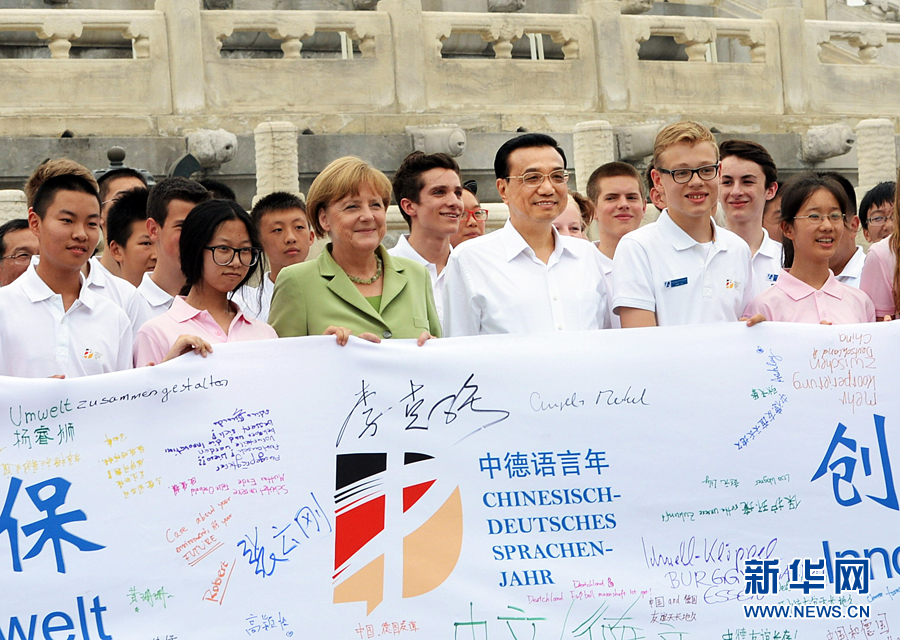 李克強同默克爾與青少年在天壇祈年殿前合影留念。