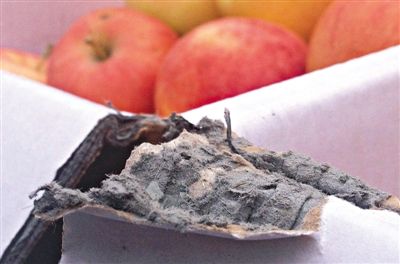 8月29日，新發(fā)地市場，一箱用“加重紙箱”包裝的蘋果正待售，紙箱夾層內(nèi)灰黑色的增重填充物清晰可見